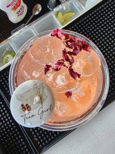 Grapefruit craft cocktail with floral garnish from our event bar